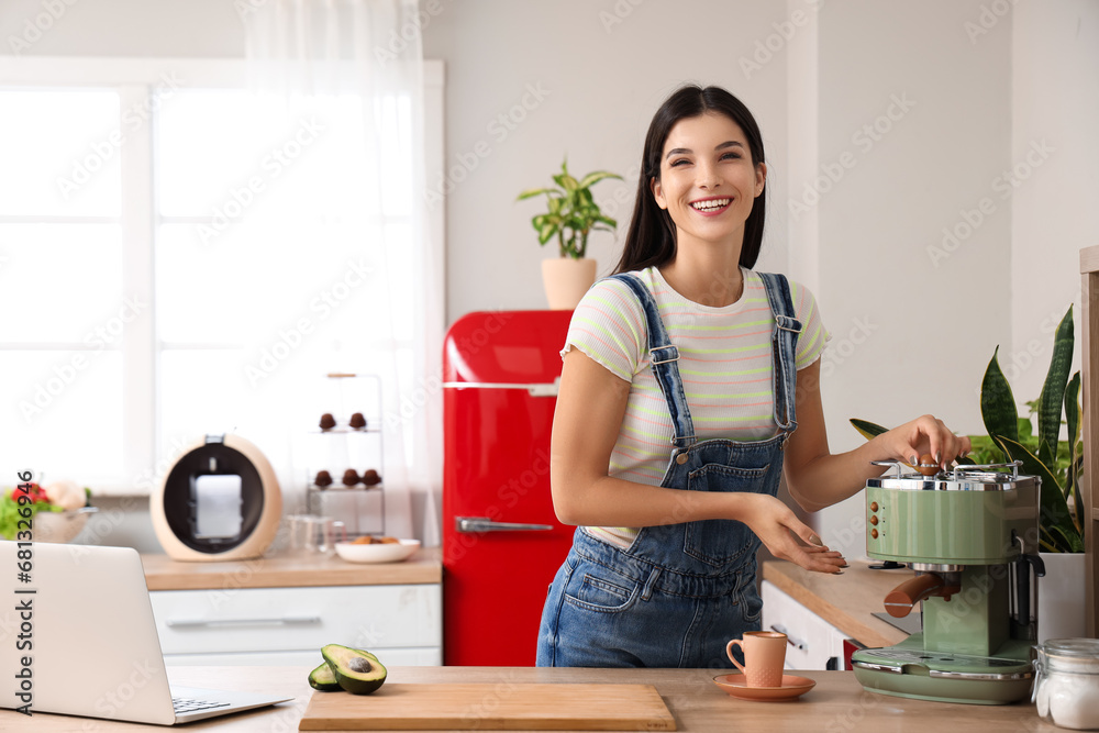 Young woman with coffee machine in kitchen Young woman with coffee machine in kitchen