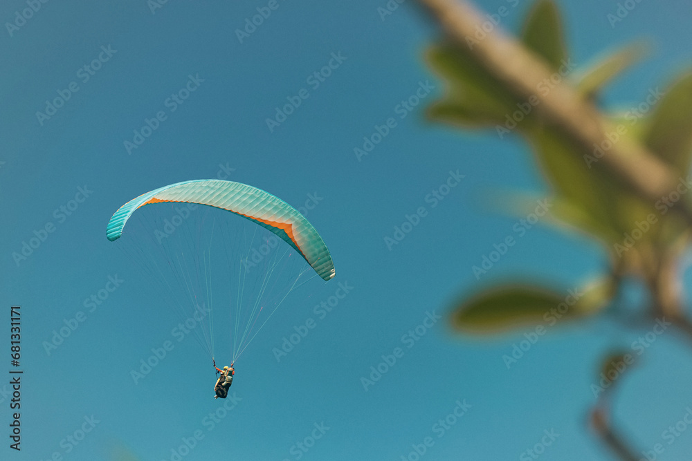 Paraglider in the sky. The sportsman flying on a paraglider. Paraglider in the sky. The sportsman flying on a paraglider.