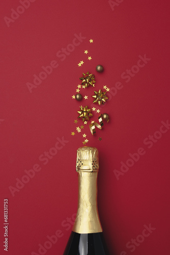 Champagne bottle with confetti stars on color background, space for text