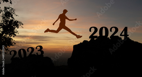 Abstract silhouette man jumping on top of mountain from 2023 text to 2024, new year 2024 concept