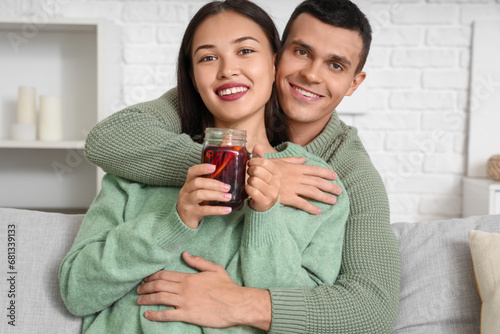 Happy young couple embracin...