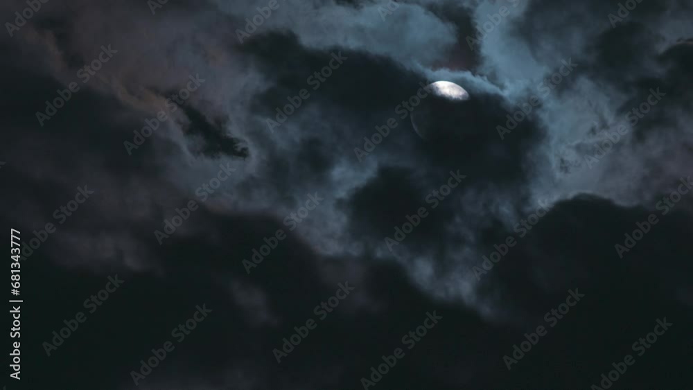 Changing clouds on the background of the full moon. Time-lapse of an atmospheric, mystical full moon on a cold autumn night Changing clouds on the background of the full moon. Time-lapse of an atmospheric, mystical full moon on a cold autumn night