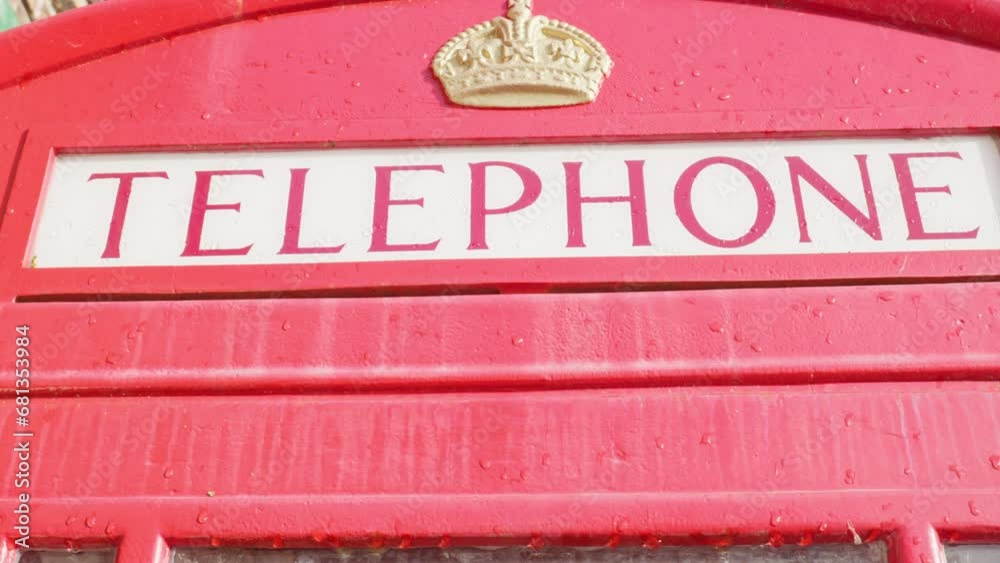 Iconic Red British K6 telephone box kiosk in rain close up upper part Iconic Red British K6 telephone box kiosk in rain close up upper part