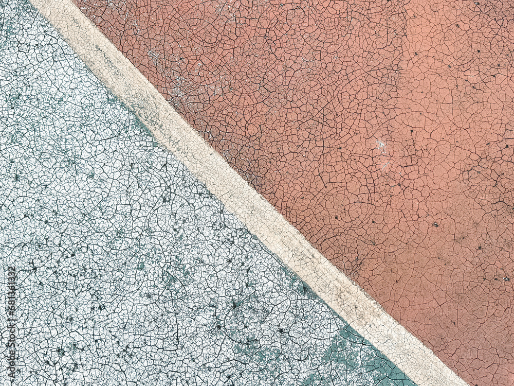 Fototapeta premium Old covering on a sports ground as an abstract background. Texture