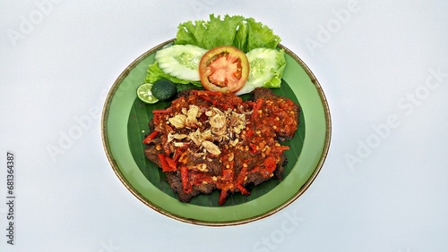 Jakarta, Indonesia - August 29, 2023: Close Up Gepuk is a Traditional Indonesian Food Made from Beef with a Sweet and Savory Taste, Usually Called Empal too. Gepuk Means Squash the Beef until Tender.  photo