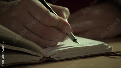 Close-up of fountain pen writing in an old-fashioned paper notebook or diary