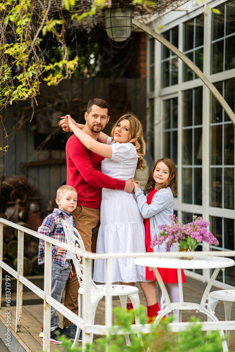 Beautiful and happy family on the terrace of the house.  © andrey