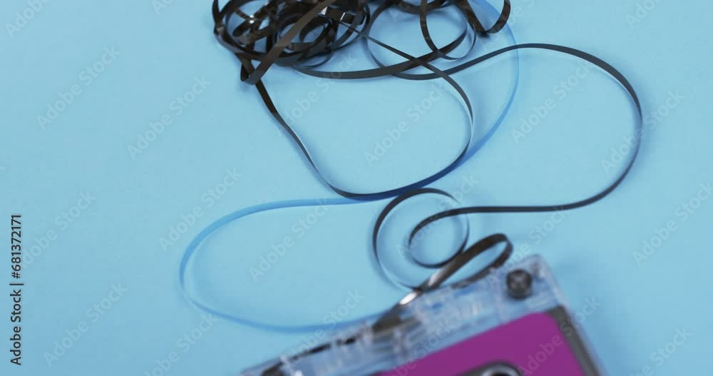 Video of retro tape with pink label and pulled out tape with copy space on blue background Video of retro tape with pink label and pulled out tape with copy space on blue background