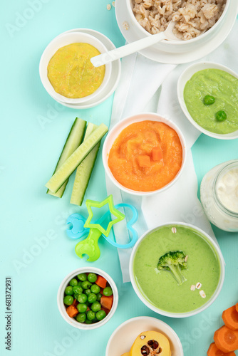 Bowls with different healthy baby food.