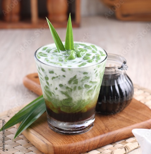 Cendol is a sweet dessert that contains droplets of green rice flour jelly, coconut milk and palm sugar syrup. It is served with shaved ice and is a refreshing snack in hot weather.  photo