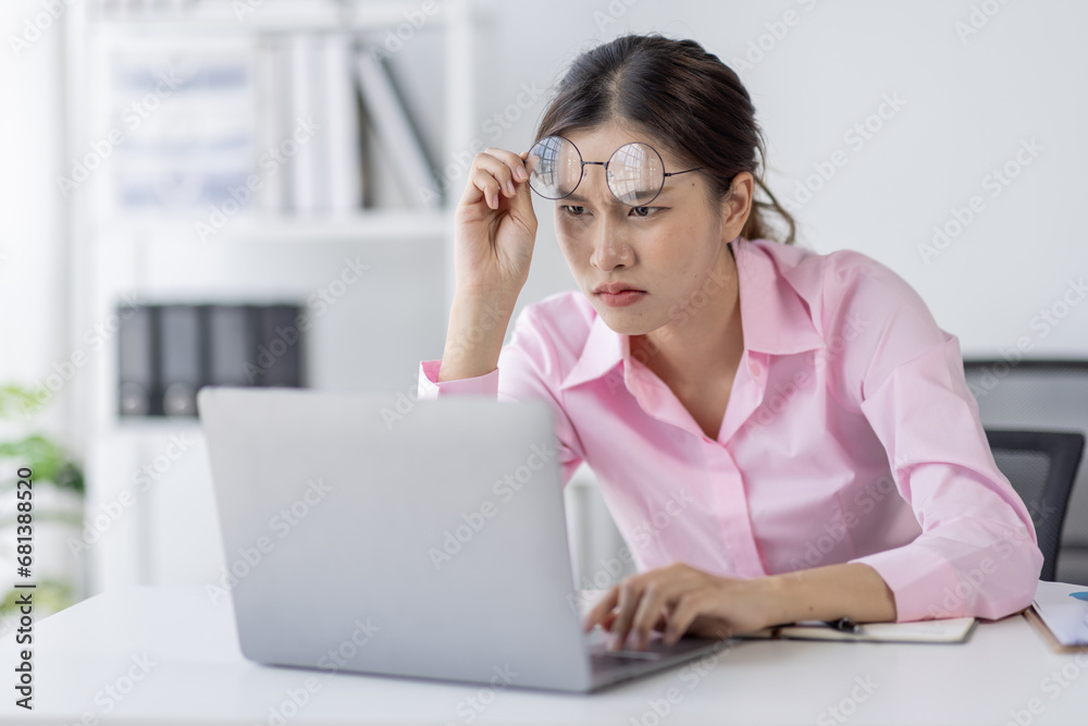 Tired exhausted or sad business young asian woman sleepy and bored from sitting at a desk.tired of working in a laptop, Tired exhausted or sad business young asian woman sleepy and bored from sitting at a desk.tired of working in a laptop,