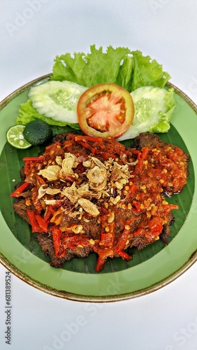 Jakarta, Indonesia - August 29, 2023: Close Up Gepuk is a Traditional Indonesian Food Made from Beef with a Sweet and Savory Taste, Usually Called Empal too. Gepuk Means Squash the Beef until Tender.  photo