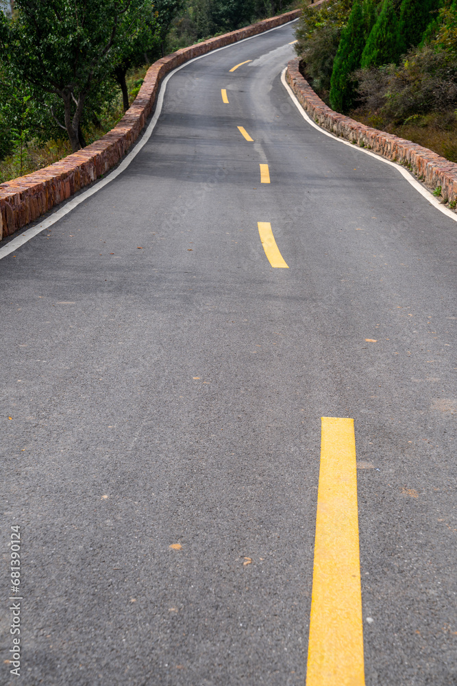 Blue sky down the hill in the asphalt road