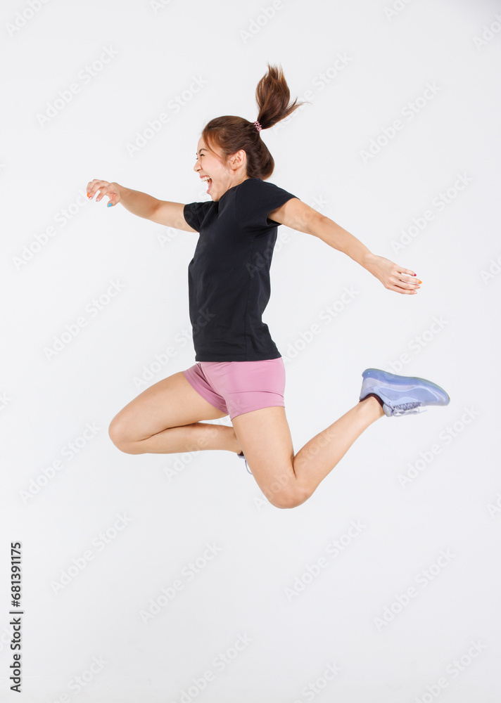 Isolated cutout full body studio shot strong Asian female fitness athlete sportswoman trainer model in casual sport workout outfit posing jumping high in air exercising training on white background