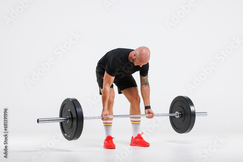 Portrait isolated cutout full body studio shot strong Caucasian male fitness athlete sporstman trainer model in casual sport workout outfit posing lifting barbell training on white background.