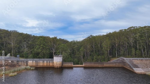 Aerial reverses back from the eerie overflow and forest of Cooloolabin Dam photo