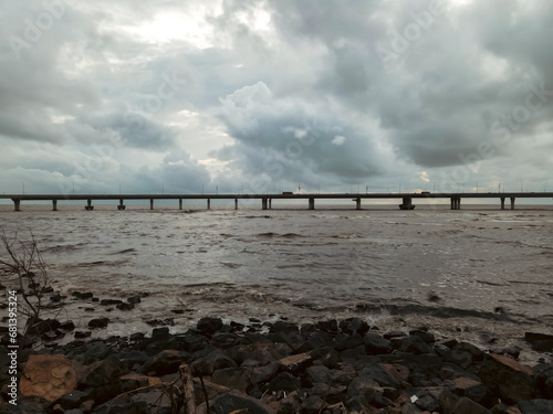 Cinematic Aerial view of vehicles Passing over Bandra Worli Sea Link in Mumbai  India. Weather in Mumbai  Sunset skyline Mumbai.