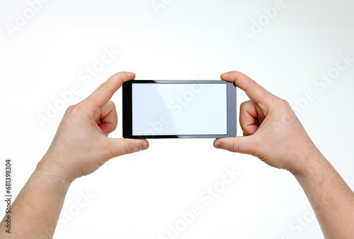Male hand hoding smartphone isolated on white background. You can insert an image image of your text for the concept or project development of mobile applications and their advertising mobile devices photo