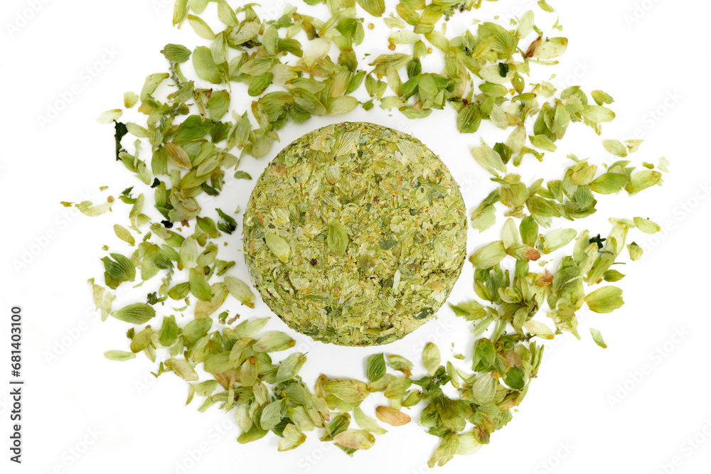 Dried hops - pressed hop puck with hop leafs photographed on white background - Czech hops from the Žatec region - Czech Republic, Europe