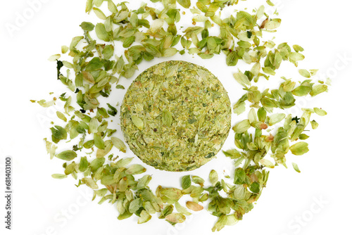 Obraz na płótnie Dried hops - pressed hop puck with hop leafs photographed on white background - Czech hops from the Žatec region - Czech Republic, Europe w salonie