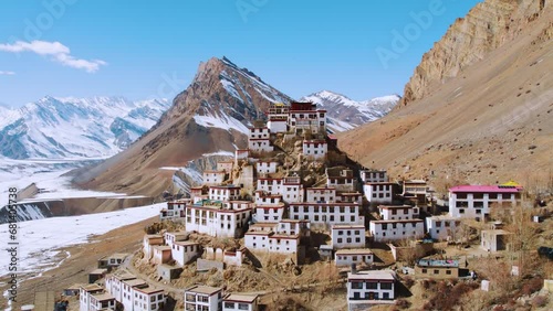 Aerial view of Key Monastery with snowy mountains in background during winter season at Kaza, Spiti Valley India. Buddhist monastery in mountains. Monastery in mountains aerial view. 4K.