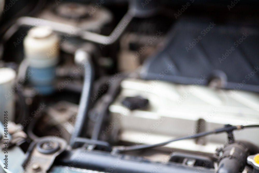 Get a glimpse under the hood of your car with this snapshot featuring engine components, hoses, and wires, an insider's view into the heart of automotive machinery Get a glimpse under the hood of your car with this snapshot featuring engine components, hoses, and wires, an insider's view into the heart of automotive machinery