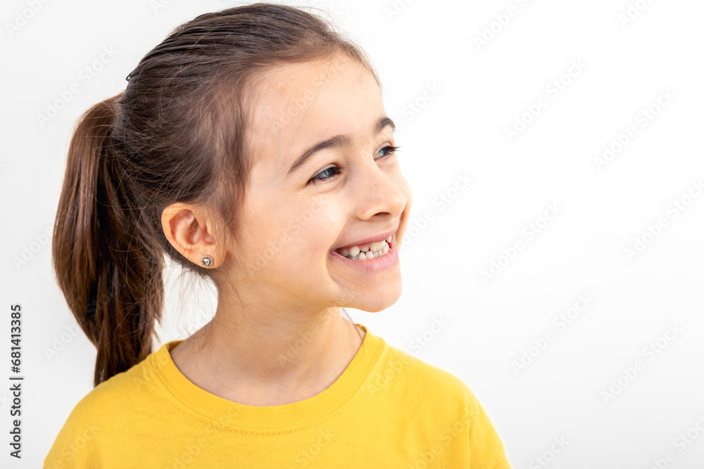 Happy little Caucasian girl smiling on white background isolated, close up. Happy little Caucasian girl smiling on white background isolated, close up.