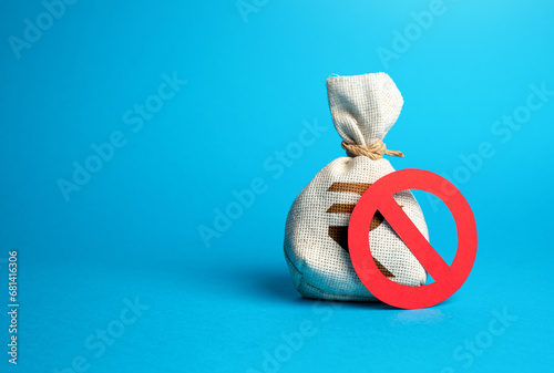 Indian rupee money bag and prohibition sign. Sanctions. Devaluation and high inflation. Refusal of settlements in national currency. Economic difficulties. Capital freeze. Capital outflow restrictions