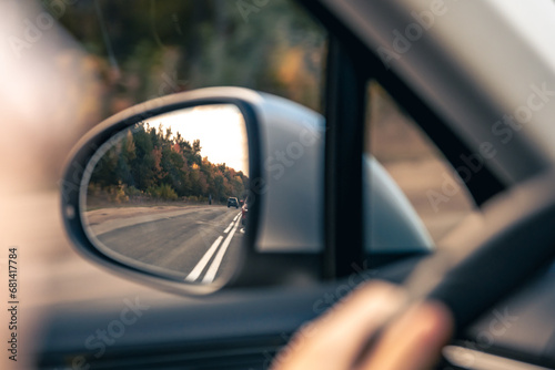 The view of the road in the car's rearview mirror. © puhimec