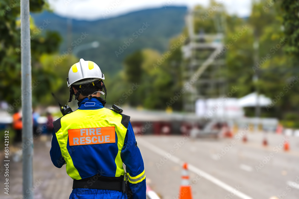 Back view fire rescue man staff on duty in racing stadium Back view fire rescue man staff on duty in racing stadium