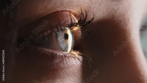 Close-up of a young woman having her vision tested on an ophthalmology diagnostic vision testing equipment. Professional ophthalmological apparatus. photo