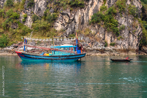 Traditional squid fishing boat with bright lights at the Cua Van floating village, Halong Bay, Vietnam