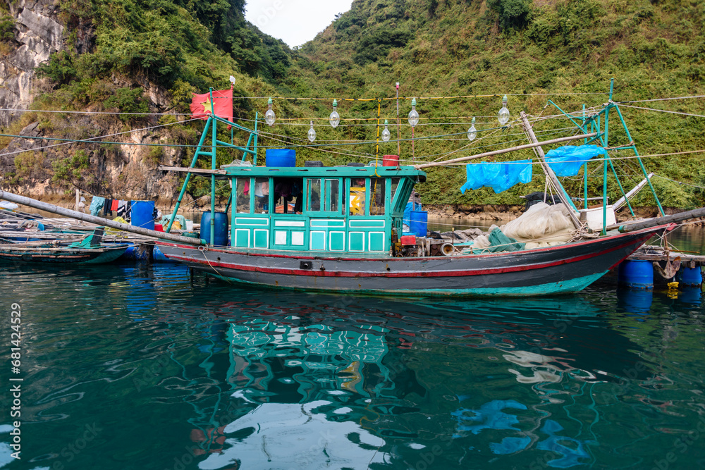 A squid boat, lined with powerful bulbs at the Cua Van floating village, Halong Bay, Vietnam