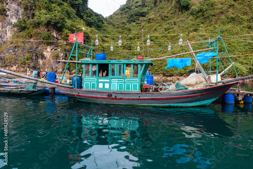 A squid boat, lined with powerful bulbs at the Cua Van floating village, Halong Bay, Vietnam