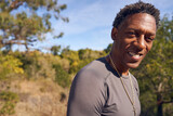 Adult Senior Black Man on Hiking Trail in Nature Smiling
