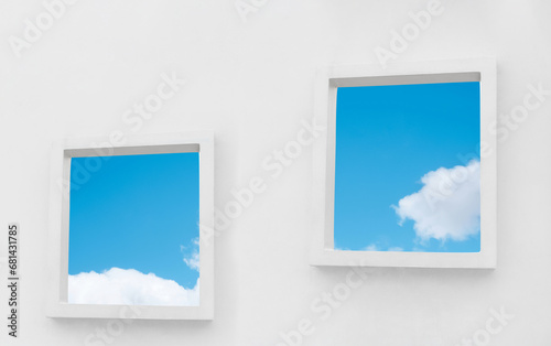 White Wall texture of concrete with open window against blue sky and clouds inSummer  Exterior Cement building with two border frame with Spring sky Ant view Modern architecture. Minimal design