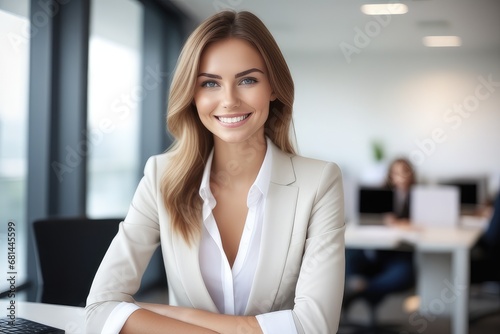 portrait of a smiling businesswoman sitting at a desk