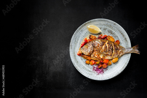 Healthy Grilled Fish Plate, Baked Fillet with Vegetable Medley on Black Background with Copy Space