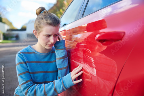 Φωτογραφία Young Worried Teenage Female Driver Looking At Damaged Car After Accident