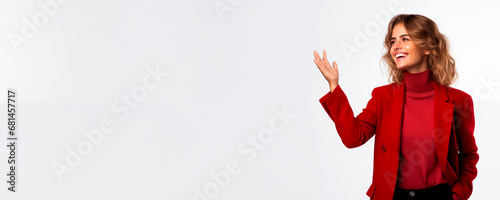 Elegant woman in red presenting with hand on white gradient. 