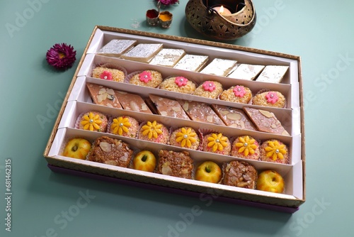 Slika na platnu Indian assorted Diwali sweets or mithai box with diya and flowers