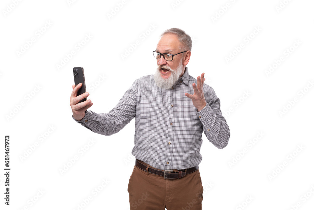 well-groomed elderly man with a gray beard and mustache takes a selfie on the phone well-groomed elderly man with a gray beard and mustache takes a selfie on the phone