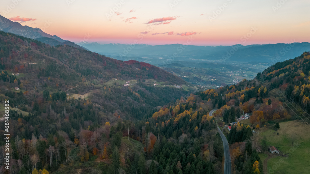 Aerial panorama of Pedavena forest.
Dolomites in the distance, autumn foliage