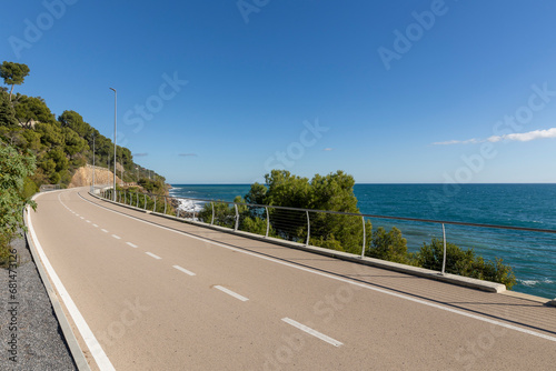 A long bike path overlooking the sea with no one around. photo