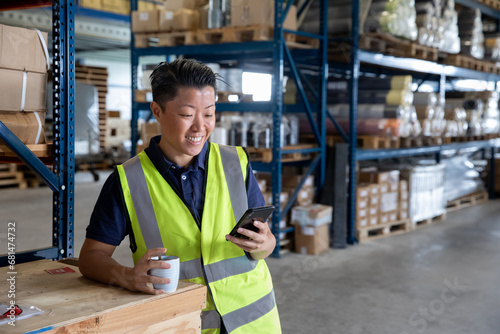 Portrait of employee in distribution warehouse on a coffee break photo