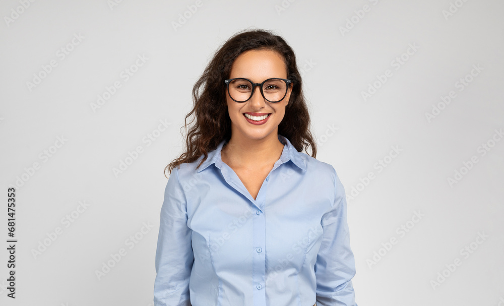 Positive pretty young caucasian businesswoman, manager in formal wear, glasses