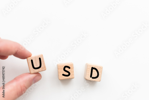 Word USD. Wooden small cubes with letters isolated on white background with copy space available.Business Concept image.