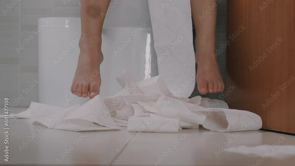 child sits on the toilet with toilet paper Training child or Health
