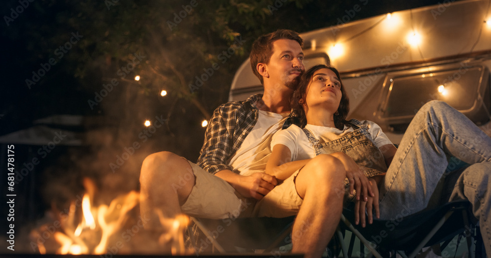 Portrait of a Young Couple Relaxing at a Caravan Camping Area in the Evening, Keeping Warm with Campfire, Looking at the Stars and Dreaming Out Ideas About a Successful Future Together
