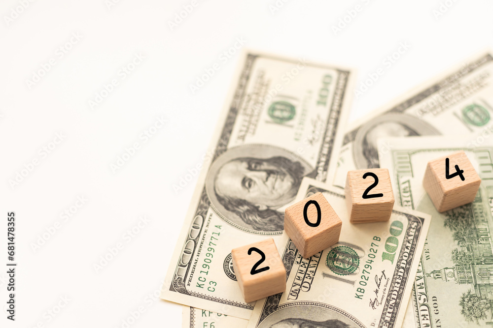 2024 inscription on wooden cubes on the texture of us dollars and euro banknotes 2024 inscription on wooden cubes on the texture of us dollars and euro banknotes